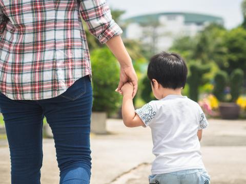 Small Child holding hand of single women divorced